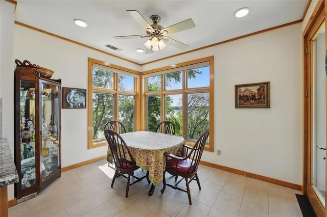 a dining room with furniture a flat screen tv and a large window