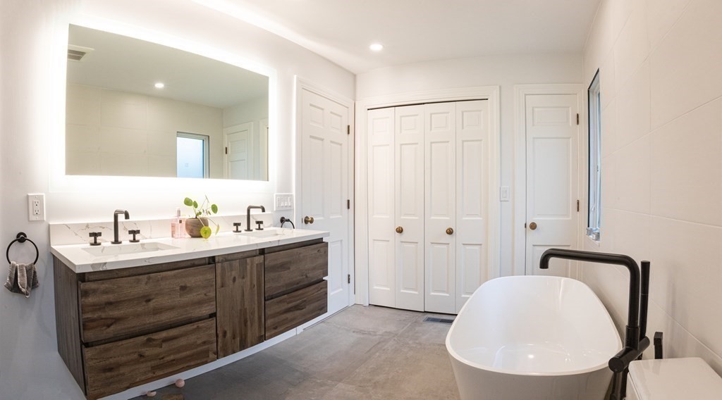 48 Amherst Road Belmont, MA 02478 - Photo 12 of 26 a bathroom with a double vanity sink mirror and