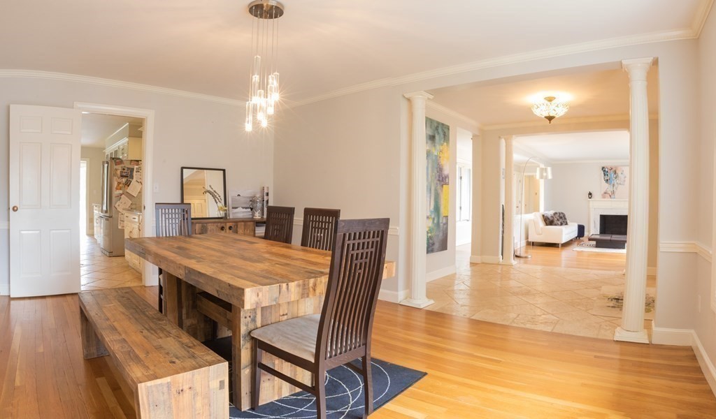 48 Amherst Road Belmont, MA 02478 - Photo 6 of 26 a dining room with wooden floor a chandelier a wooden table and chairs