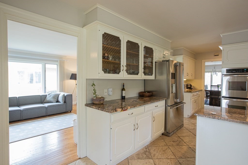 48 Amherst Road Belmont, MA 02478 - Photo 9 of 26 a large kitchen with a counter top space a sink a refrigerator and windows