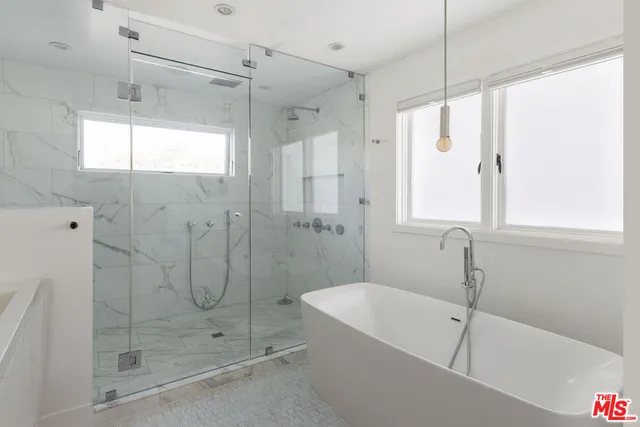 a bathroom with a bathtub and shower