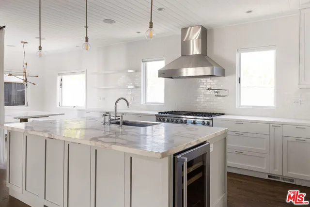 a kitchen with cabinets appliances and a window
