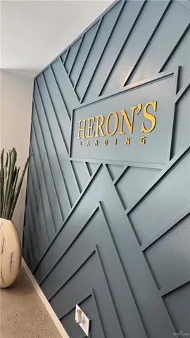 a living room with a table chairs and a refrigerator