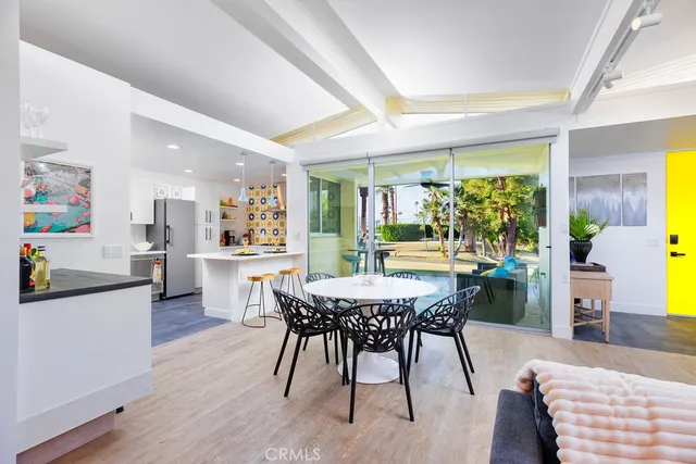 a view of a dining room with furniture and a large window
