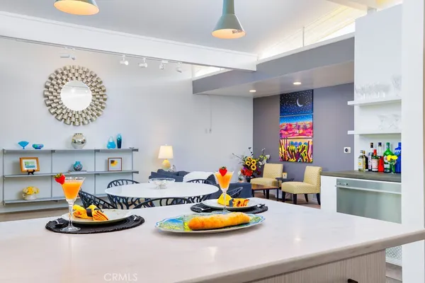a kitchen with a refrigerator and a wooden floor