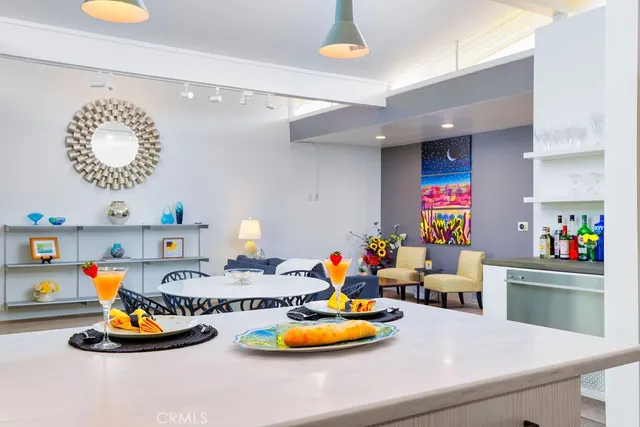 a kitchen with a refrigerator and a wooden floor