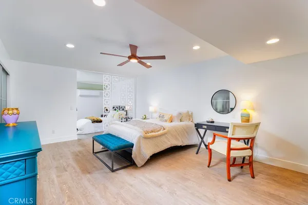 a bedroom with bed and a chandelier