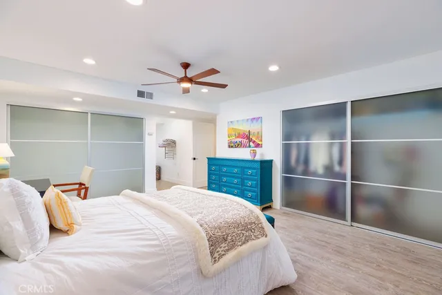 a bedroom with a large bed closet and a window