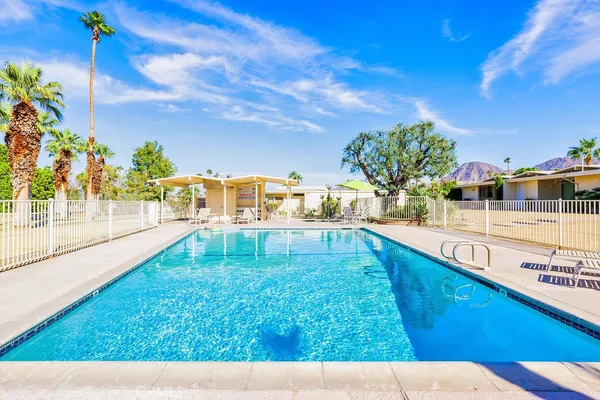 a view of a swimming pool with a lawn chairs