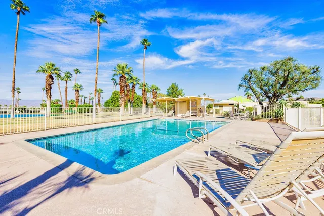 a view of a swimming pool with a lounge chairs