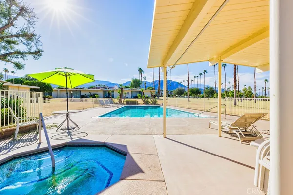 a view of swimming pool with outdoor seating