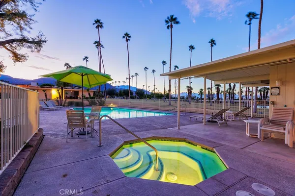 a view of a swimming pool with an outdoor seating