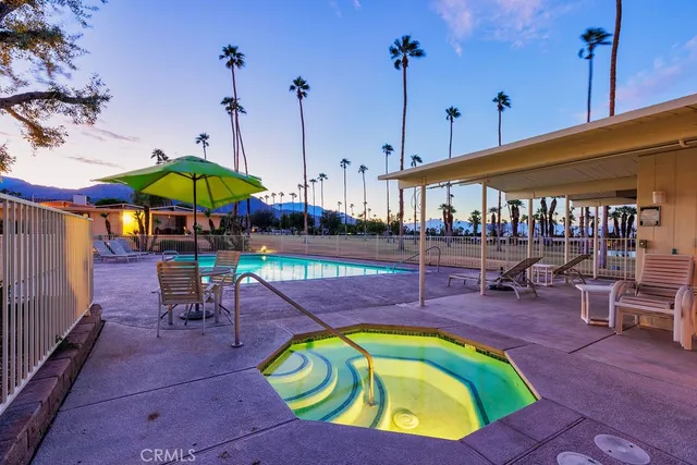 a view of a swimming pool with an outdoor seating