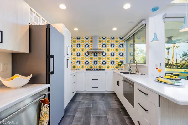 a kitchen with stainless steel appliances a sink and a refrigerator