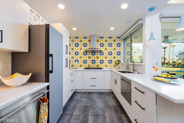 a kitchen with stainless steel appliances a sink and a refrigerator
