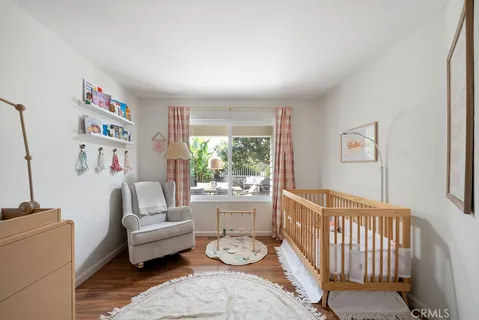 a bedroom with furniture and a wooden floor