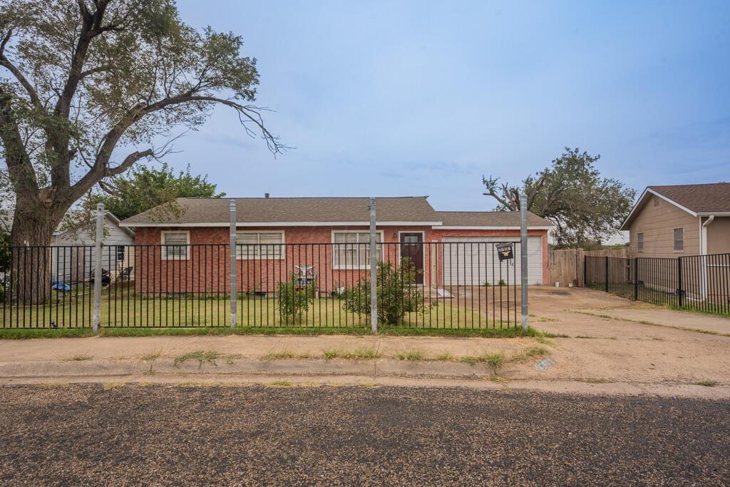 a view of front of a house with a small yard and plants