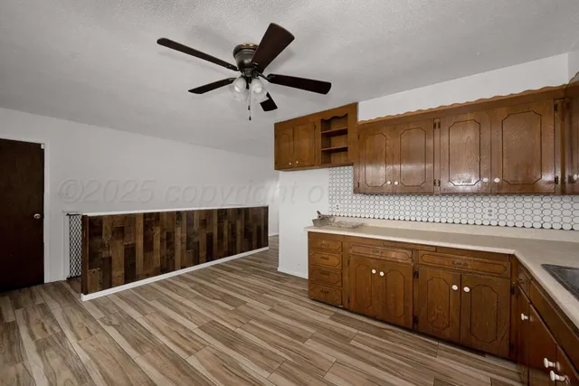 a kitchen with a sink cabinets and appliances