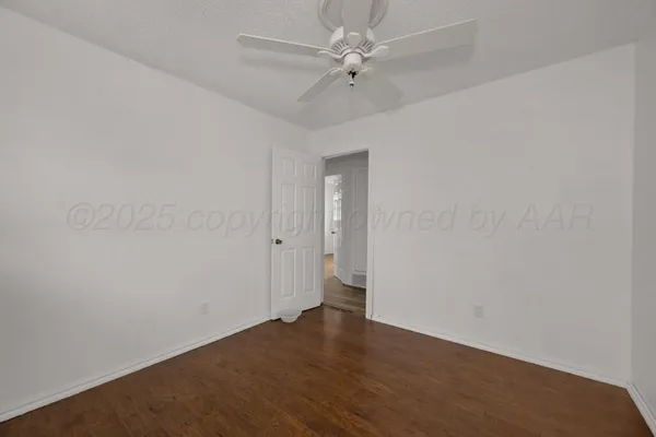 a view of an empty room with a fan
