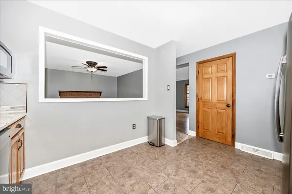 a living room with furniture a ceiling fan and a window