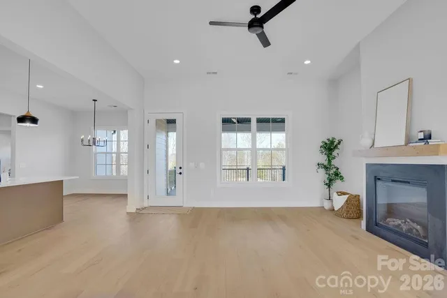 a view of an empty room with a fireplace and a window
