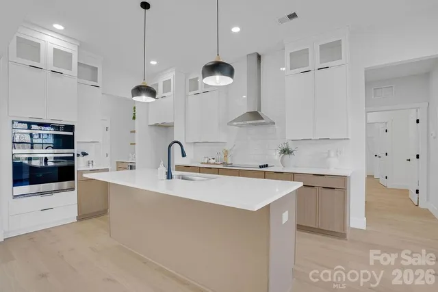 a large kitchen with stainless steel appliances kitchen island a large island in the center