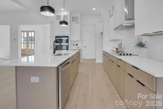a kitchen with kitchen island white cabinets and refrigerator