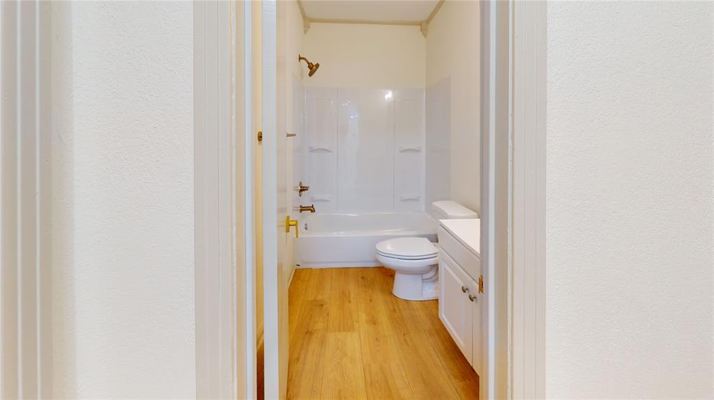3725 Colina Lane Waco, TX 76705 - Photo 21 of 30 a bathroom with a granite countertop toilet a sink and a mirror