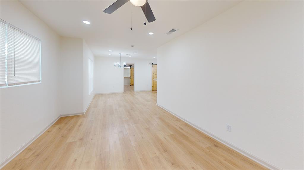 3725 Colina Lane Waco, TX 76705 - Photo 28 of 30 an empty room with wooden floor and windows