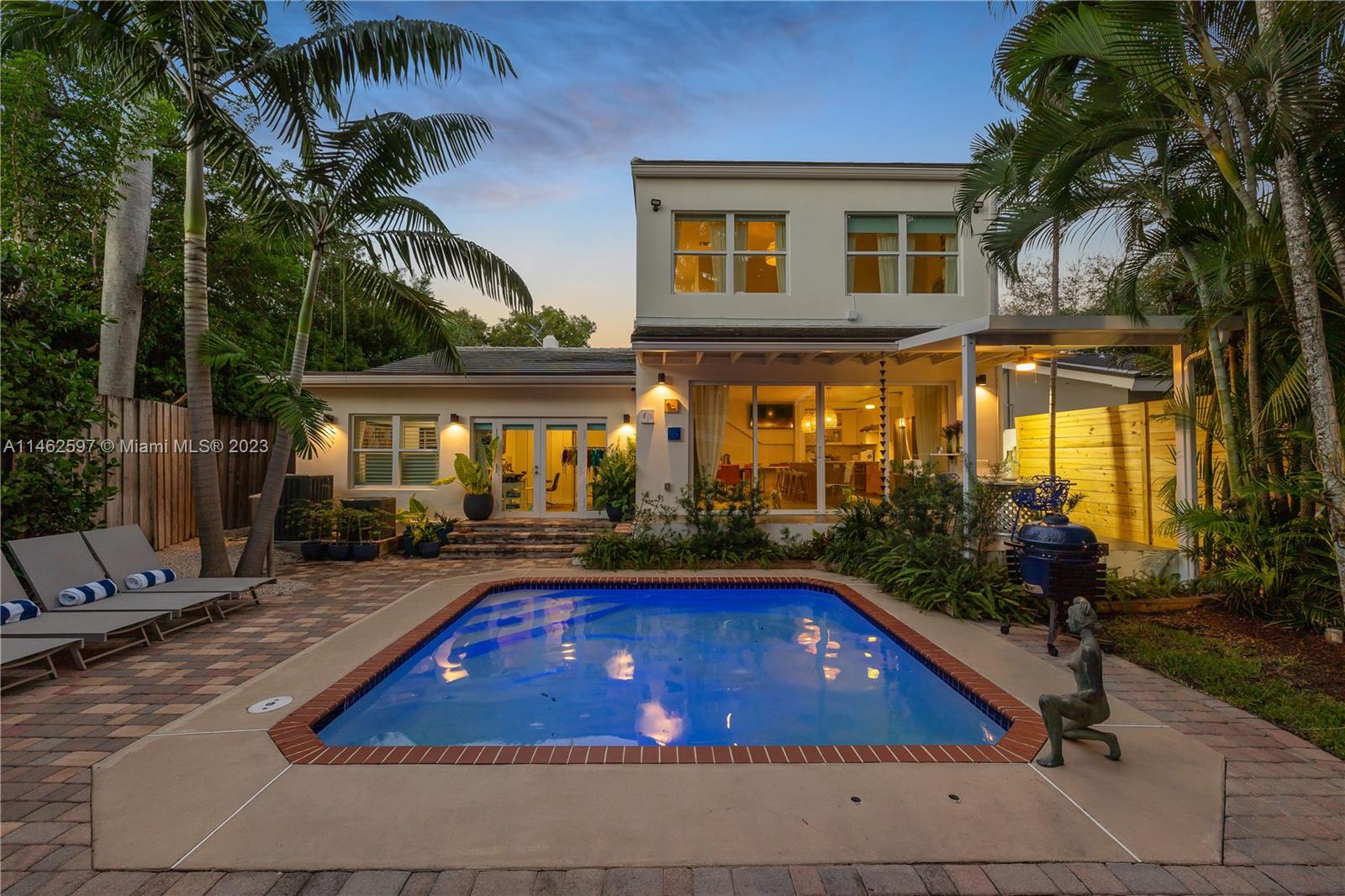 a view of a house with swimming pool and sitting area