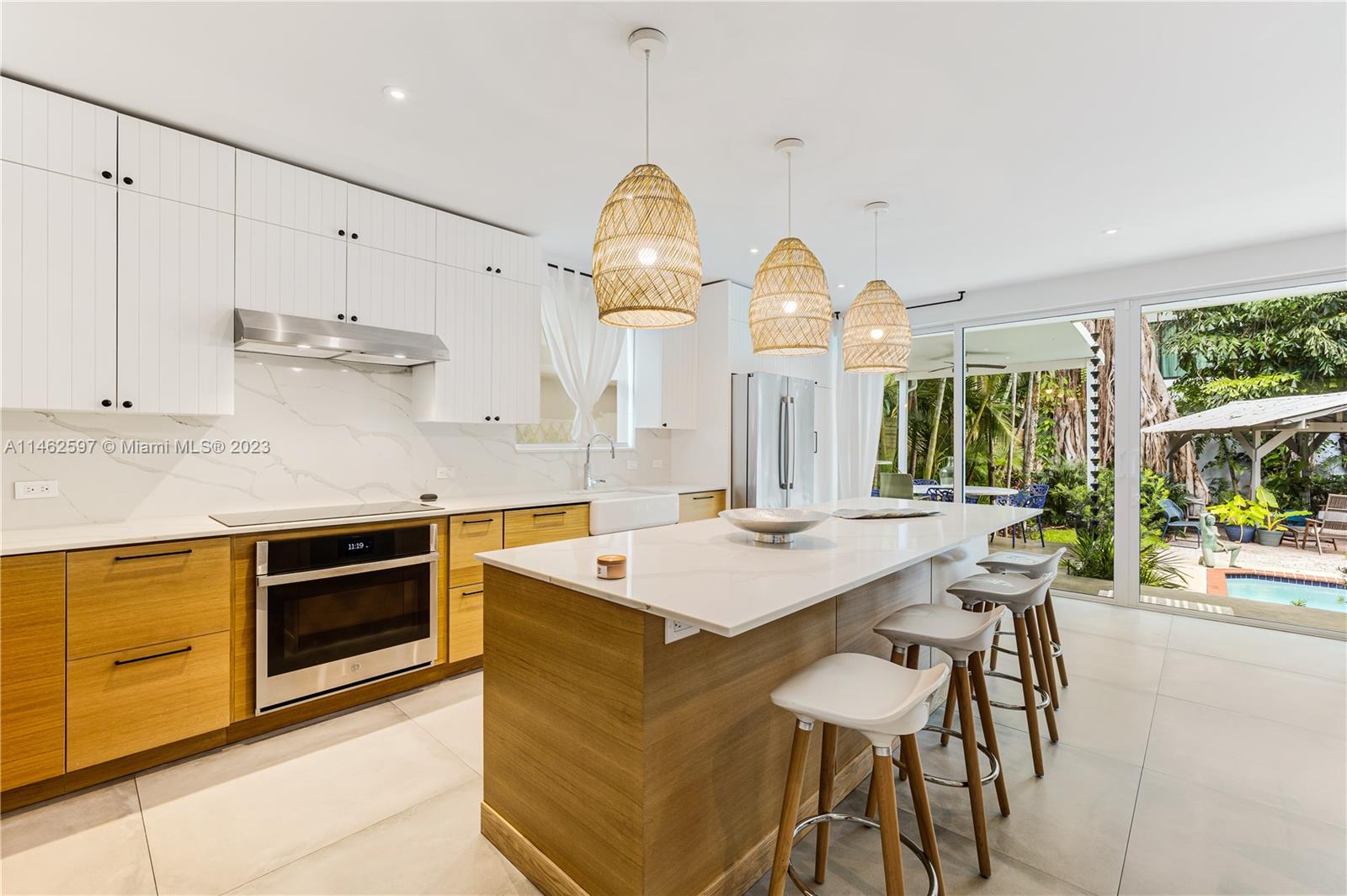 32 Southwest 23rd Road Miami, FL 33129 - Photo 12 of 34 a kitchen with stainless steel appliances granite countertop a stove a sink dishwasher and a dining table with garden view