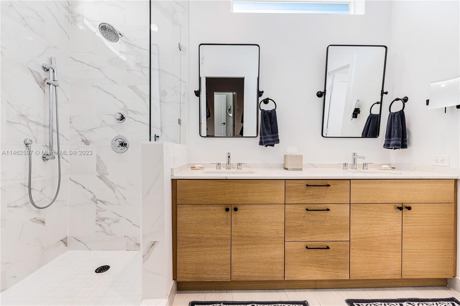 32 Southwest 23rd Road Miami, FL 33129 - Photo 15 of 34 a bathroom with a double vanity sink a mirror and shower