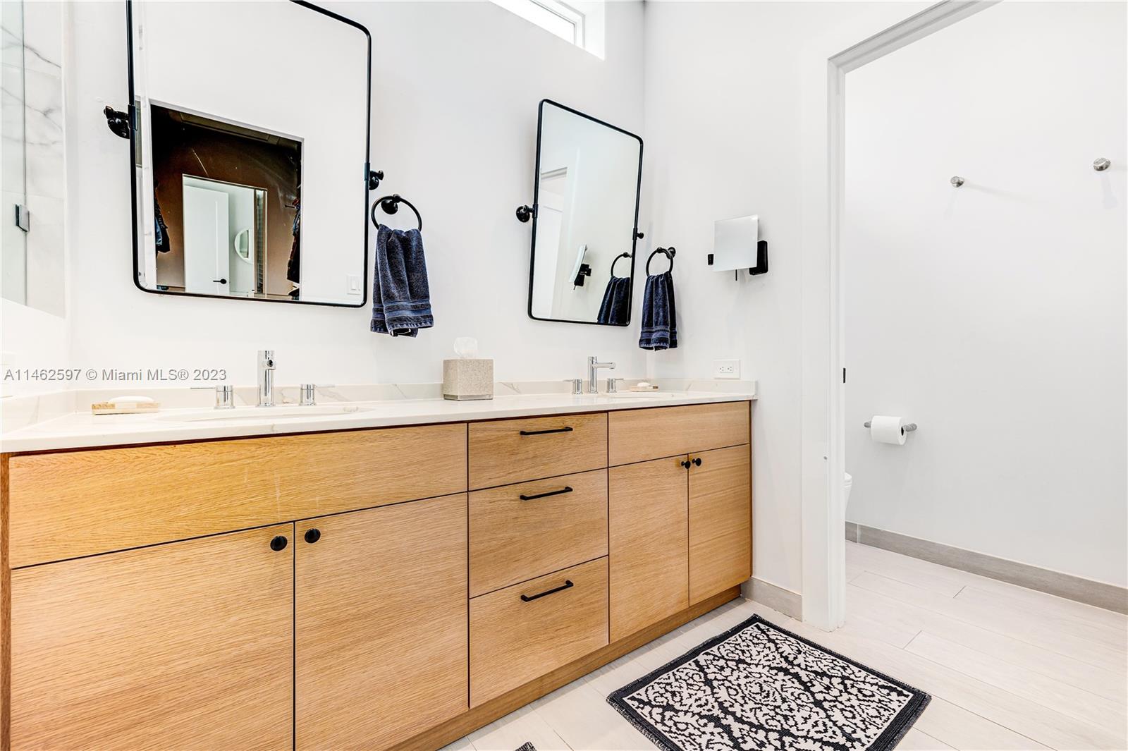 32 Southwest 23rd Road Miami, FL 33129 - Photo 16 of 34 a bathroom with a double vanity sink and a mirror