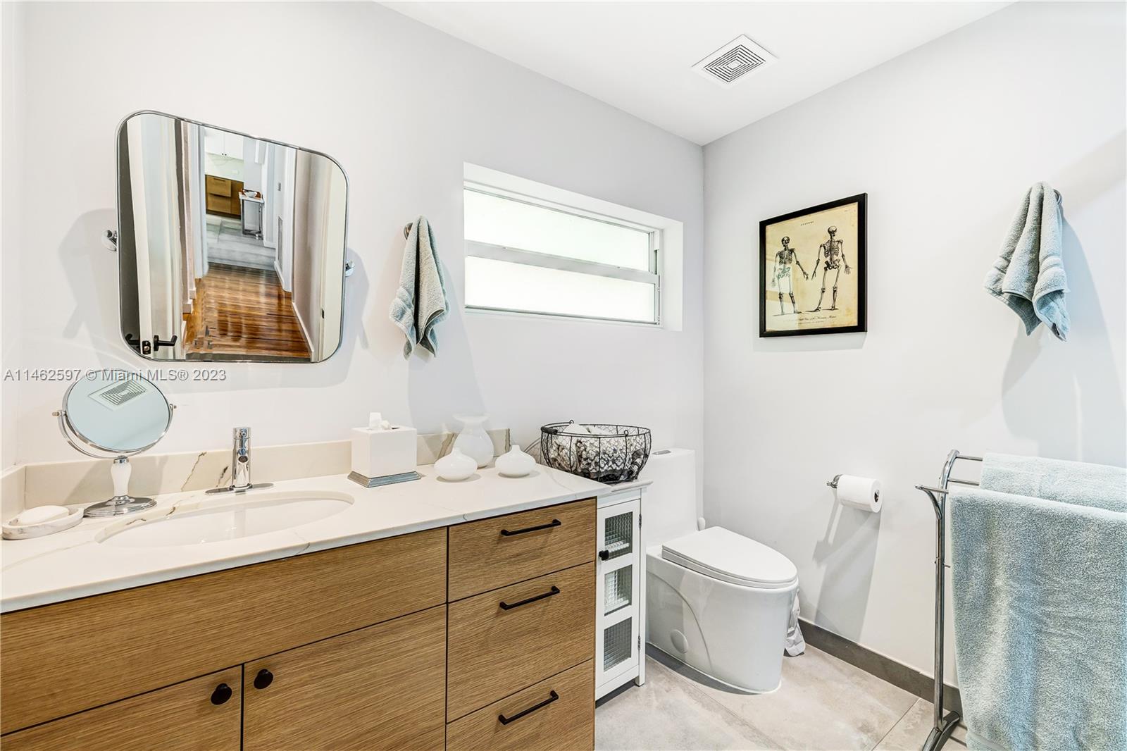 32 Southwest 23rd Road Miami, FL 33129 - Photo 21 of 34 a bathroom with a toilet a sink and mirror