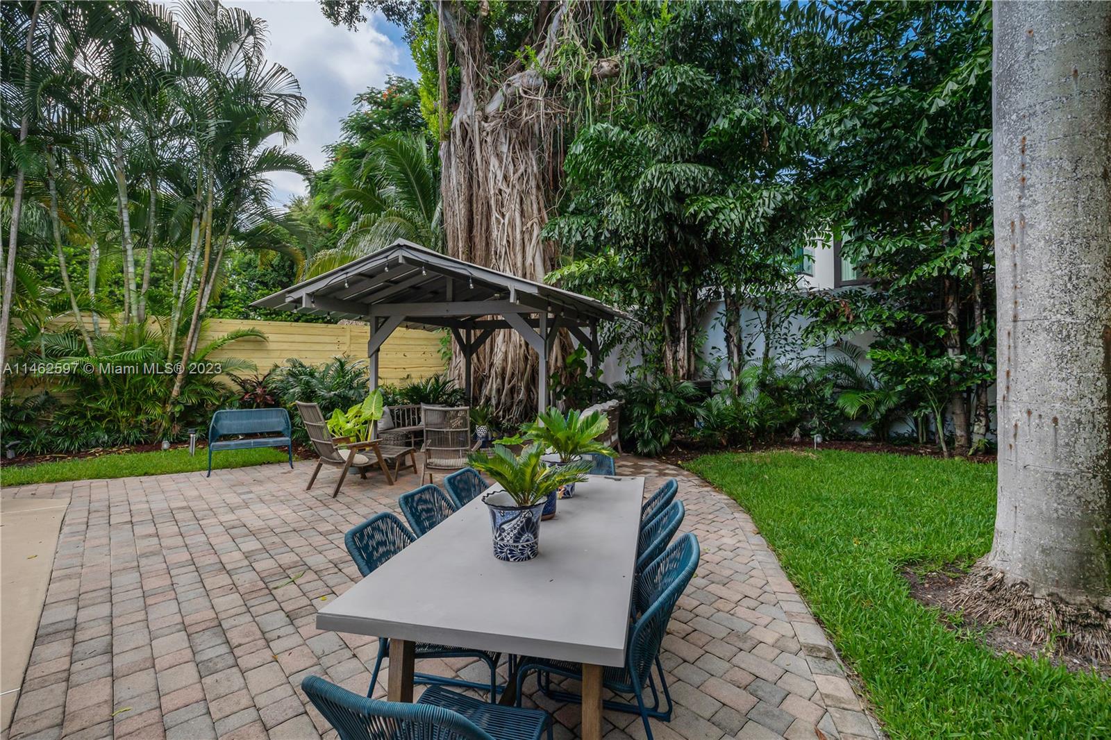32 Southwest 23rd Road Miami, FL 33129 - Photo 27 of 34 a view of backyard with outdoor seating and trees