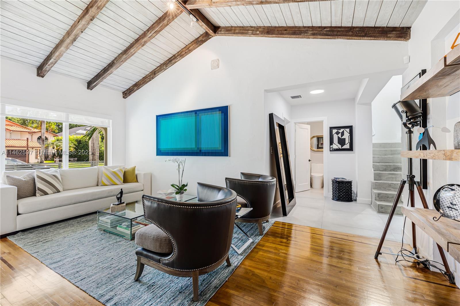 32 Southwest 23rd Road Miami, FL 33129 - Photo 5 of 34 a living room with furniture a flat screen tv and a table