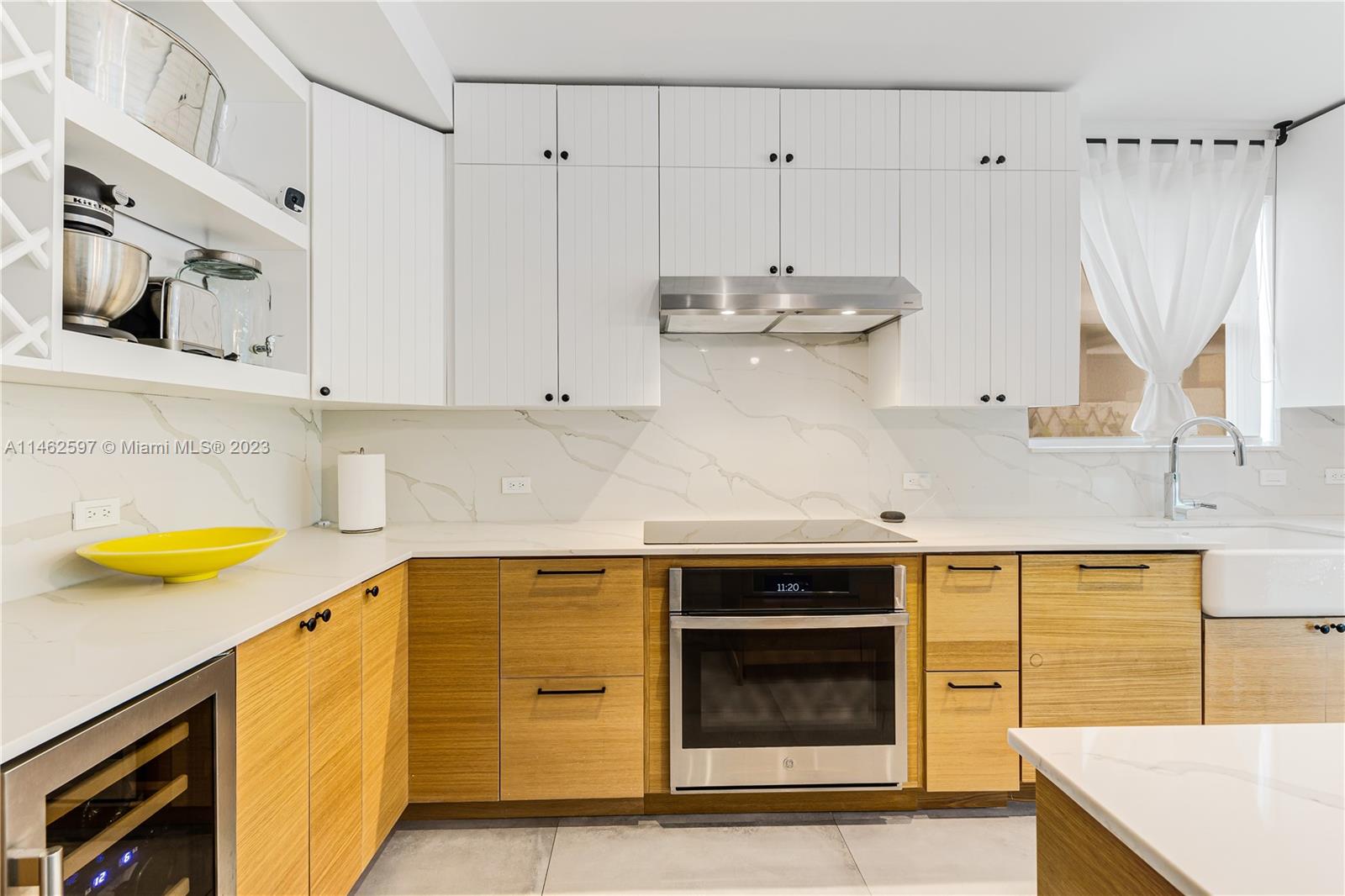 32 Southwest 23rd Road Miami, FL 33129 - Photo 10 of 34 a kitchen with stainless steel appliances a stove a sink and a microwave