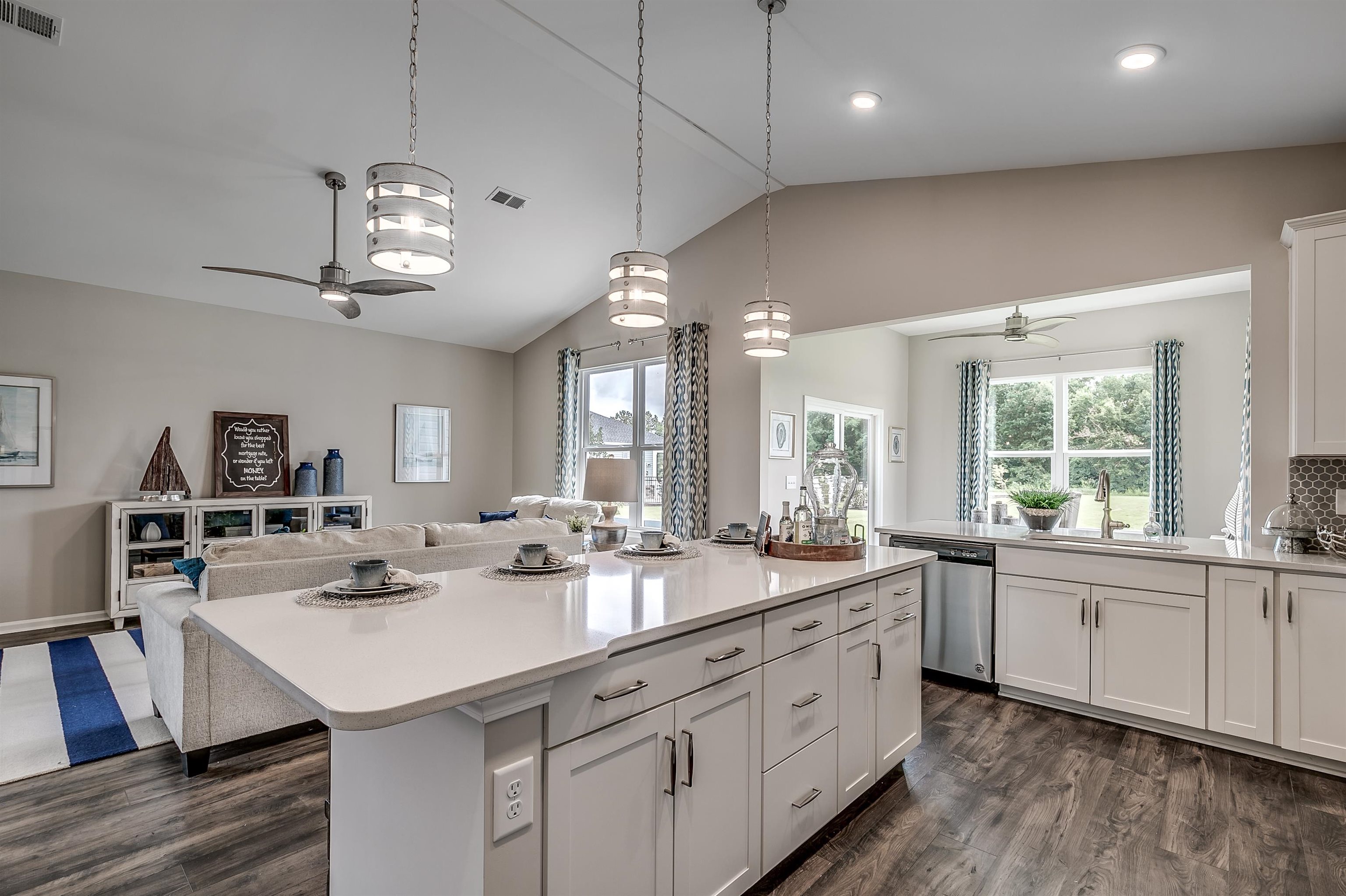 580 Kapalua Loop Little River, SC 29566 - Photo 24 of 24 Kitchen featuring ceiling fan, open floor plan, white cabinetry, pendant lighting, and lofted ceiling