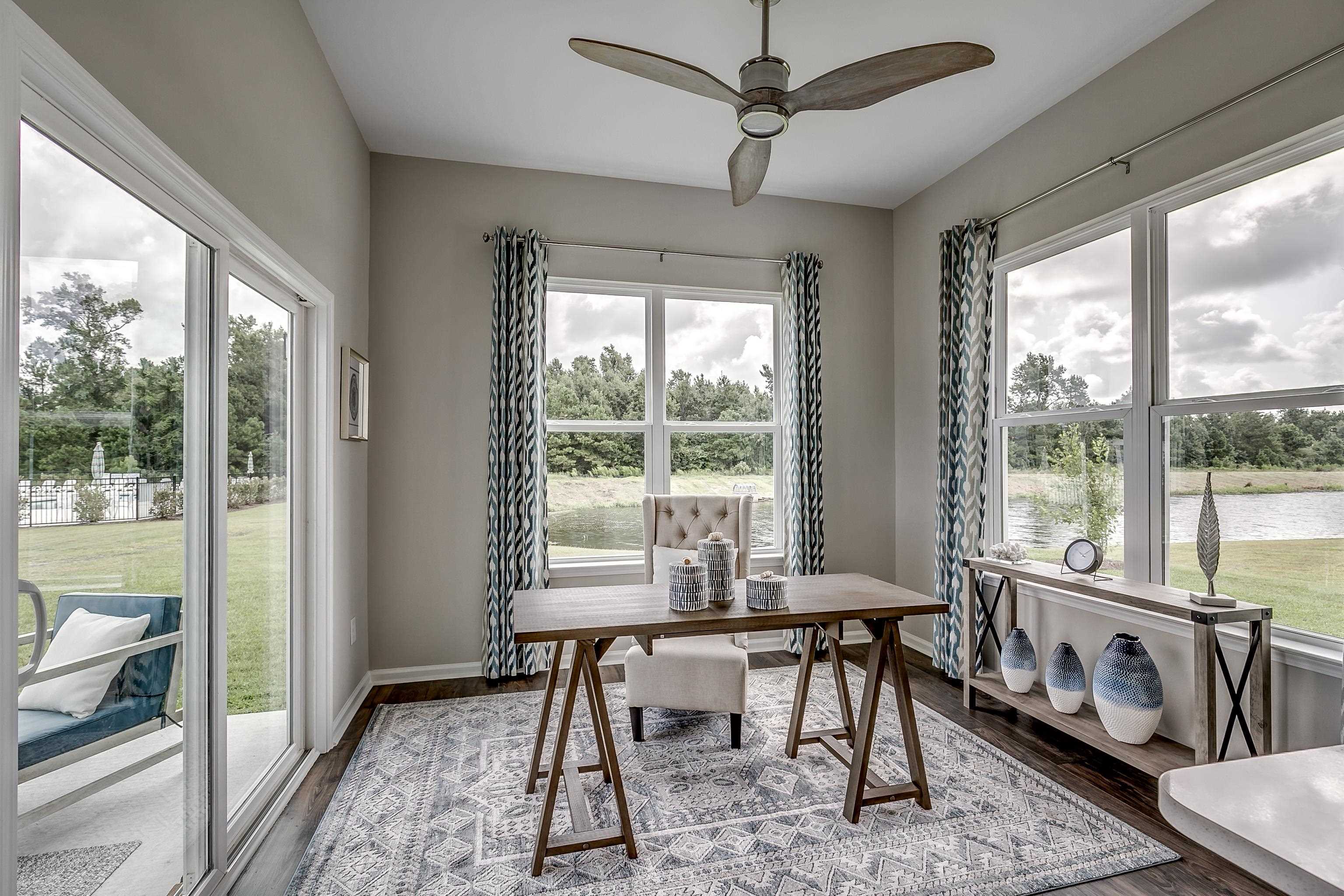 580 Kapalua Loop Little River, SC 29566 - Photo 9 of 24 Dining area featuring a desk, healthy amount of natural light, and dark wood-style flooring