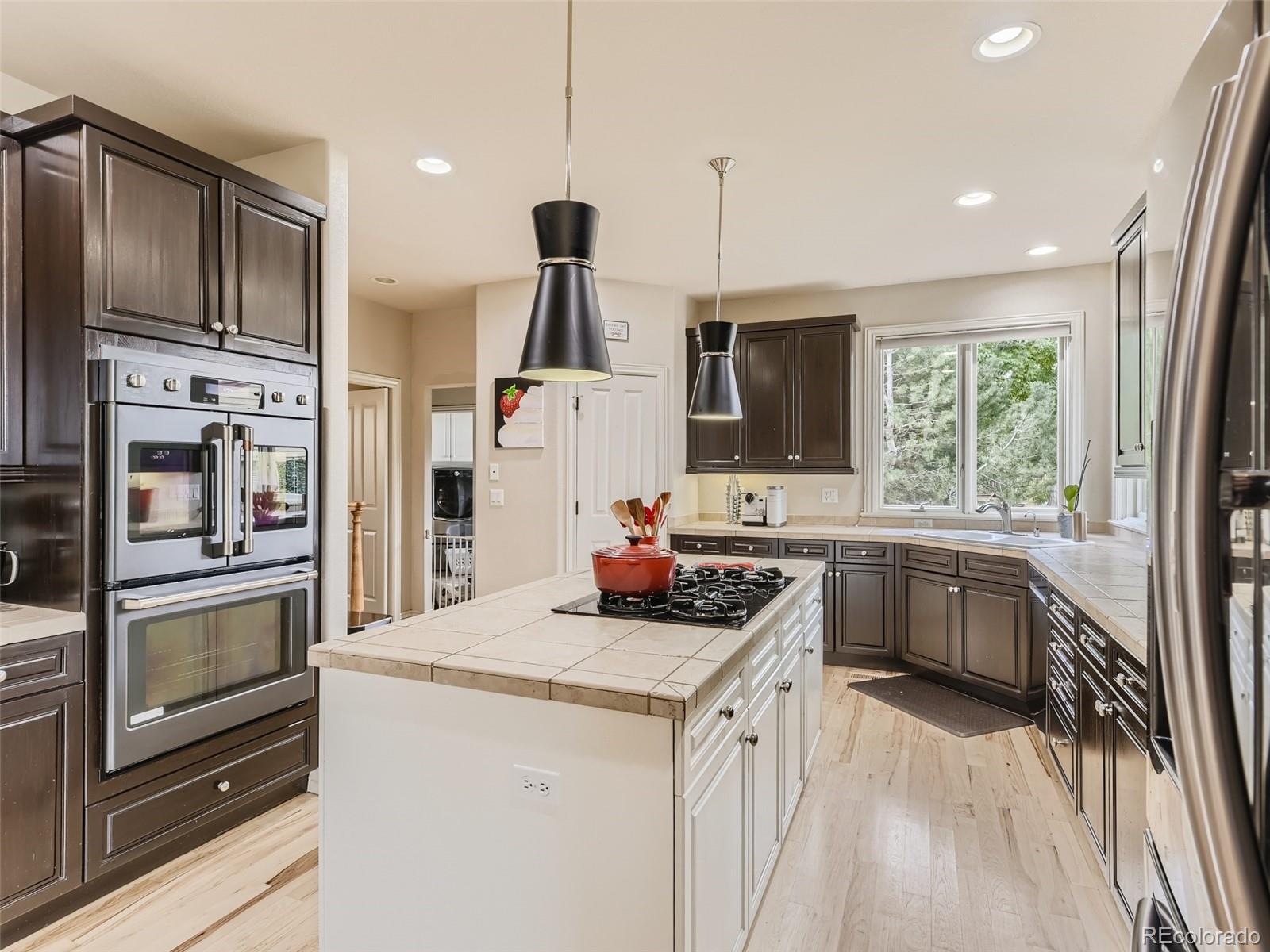 992 West Ridge Road Littleton, CO 80120 - Photo 11 of 44 a kitchen with a refrigerator sink and stove top oven
