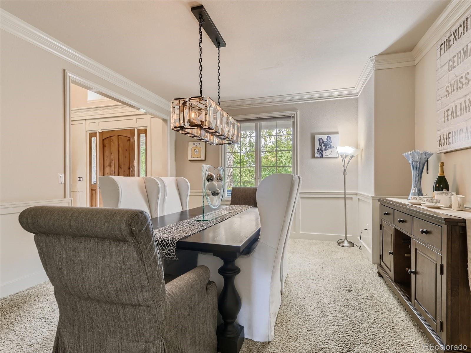 992 West Ridge Road Littleton, CO 80120 - Photo 12 of 44 a view of a dining room with furniture and chandelier