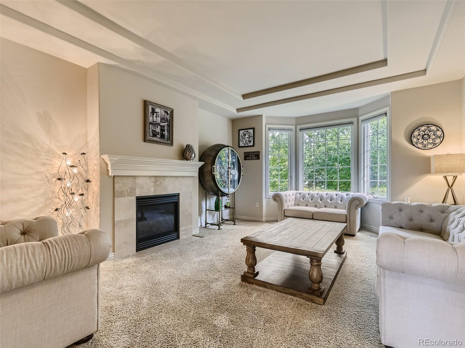 992 West Ridge Road Littleton, CO 80120 - Photo 15 of 44 a living room with furniture a fireplace and a large window
