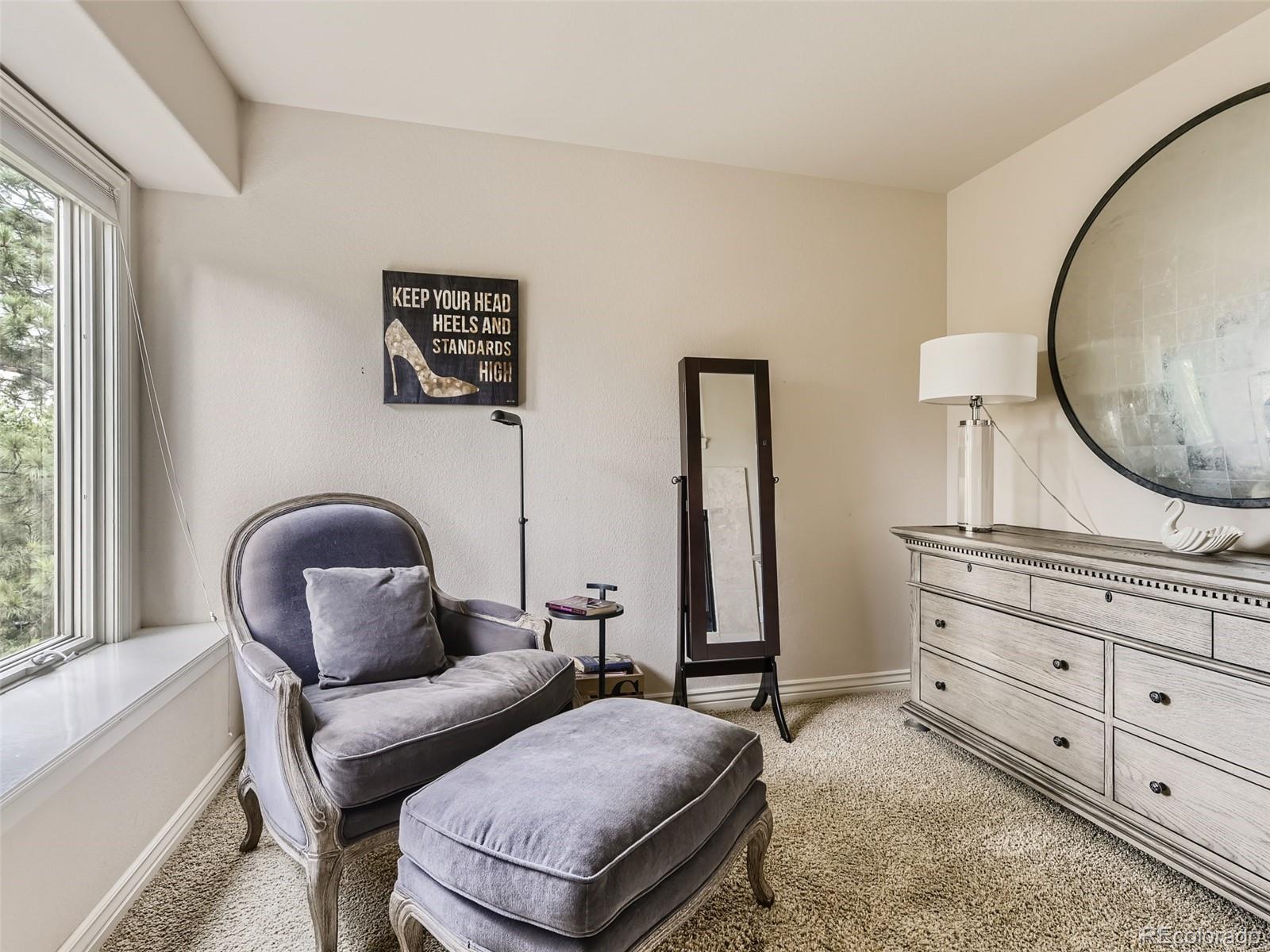 992 West Ridge Road Littleton, CO 80120 - Photo 17 of 44 a bedroom with furniture and a mirror