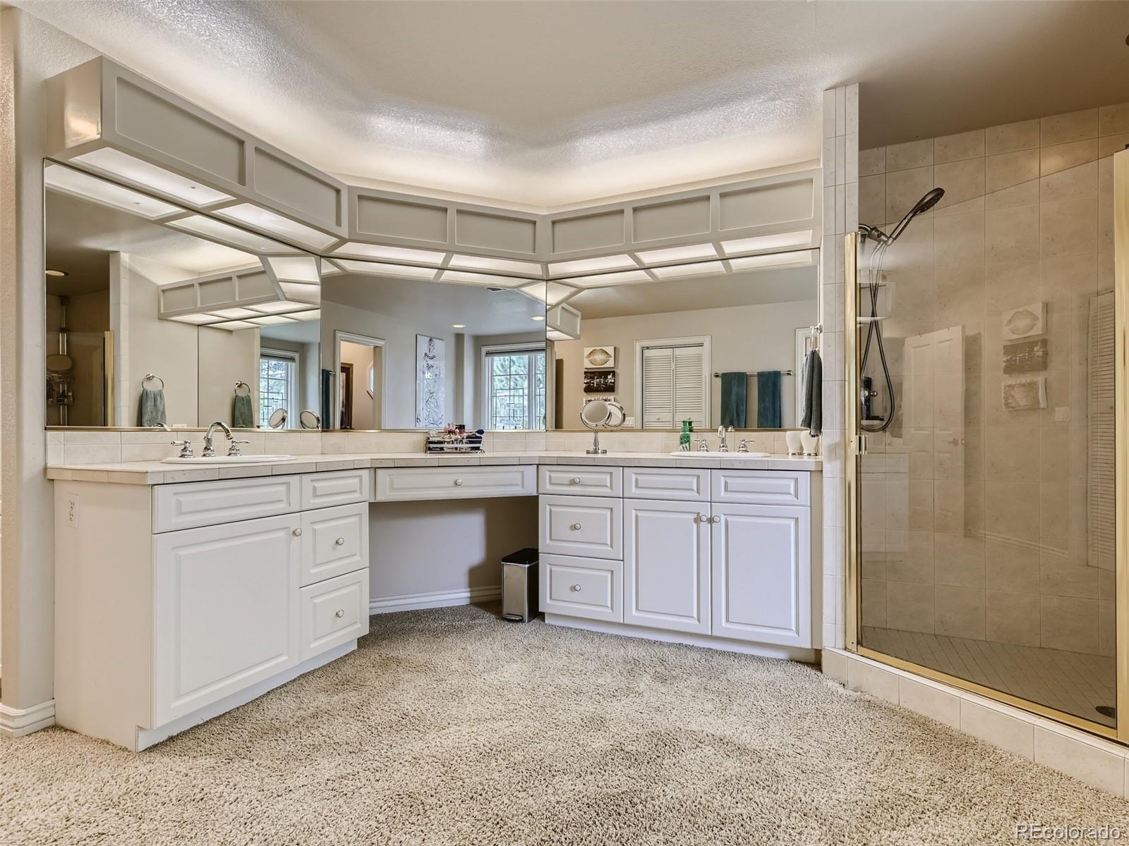 992 West Ridge Road Littleton, CO 80120 - Photo 19 of 44 a bathroom with a granite countertop sink mirror and shower