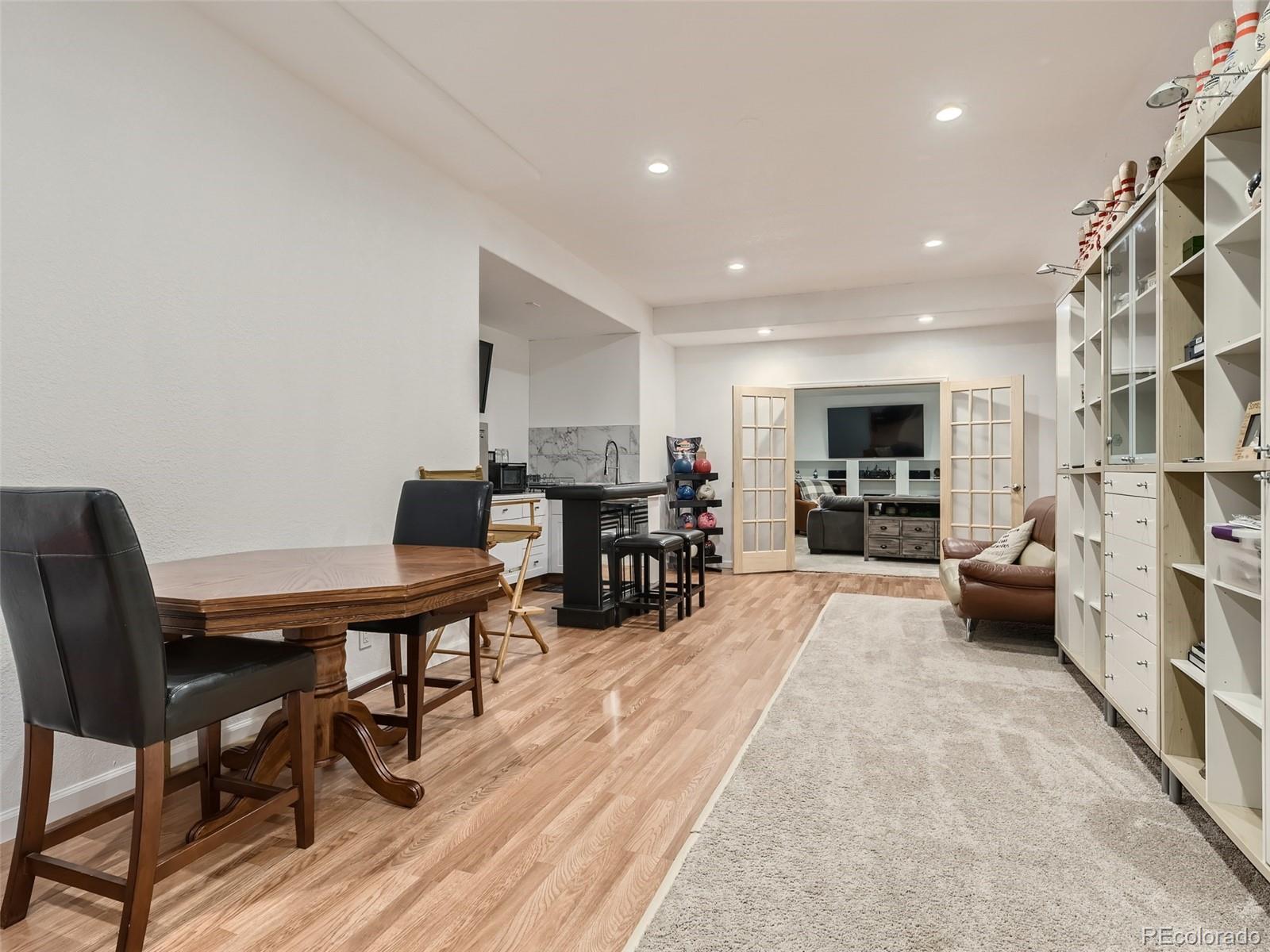 992 West Ridge Road Littleton, CO 80120 - Photo 22 of 44 a living room with furniture and a flat screen tv