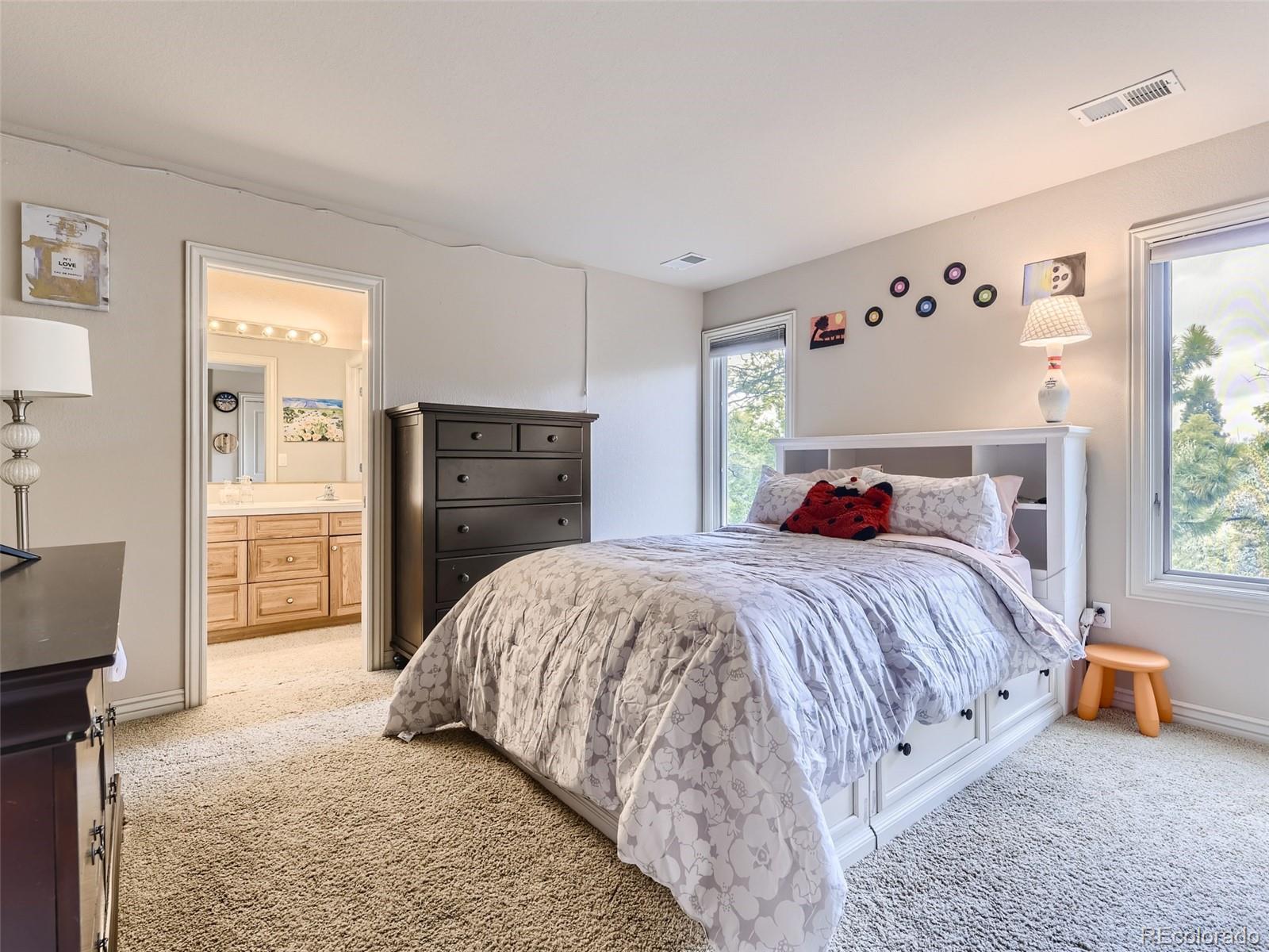 992 West Ridge Road Littleton, CO 80120 - Photo 25 of 44 a bedroom with a bed and a dresser