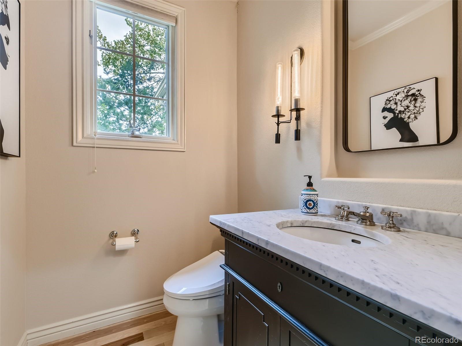 992 West Ridge Road Littleton, CO 80120 - Photo 29 of 44 a bathroom with a granite countertop toilet sink and mirror