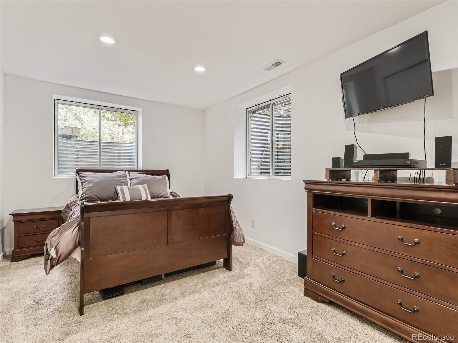 992 West Ridge Road Littleton, CO 80120 - Photo 30 of 44 a living room with furniture and a flat screen tv