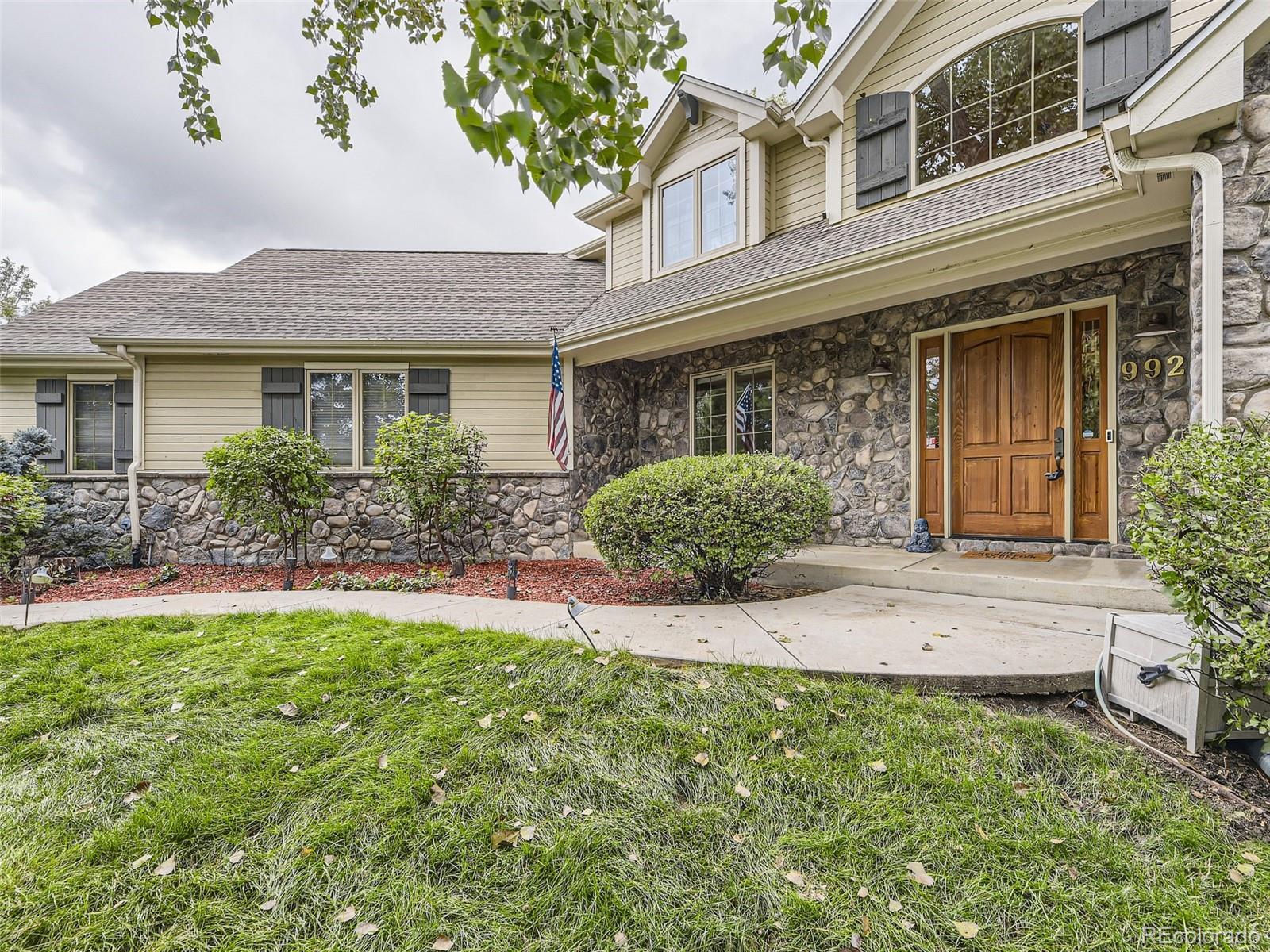 992 West Ridge Road Littleton, CO 80120 - Photo 43 of 44 front view of a house with a yard