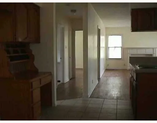 a view of a kitchen from the hallway